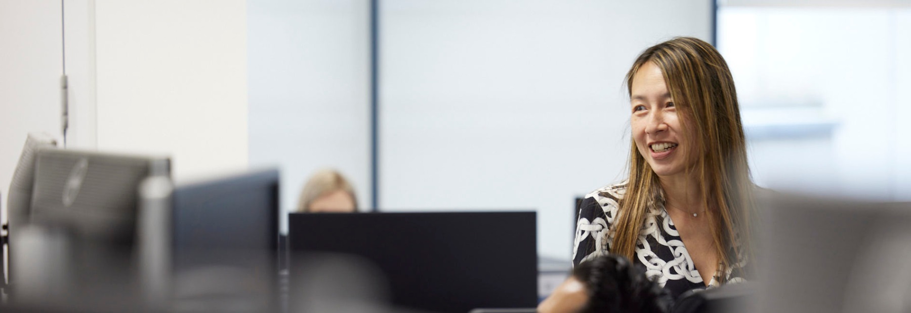 Colleague standing in office smiling