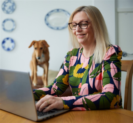 PPF Member on laptop with dog in background