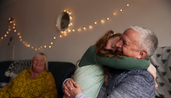 PPF member hugging grandchild in living room