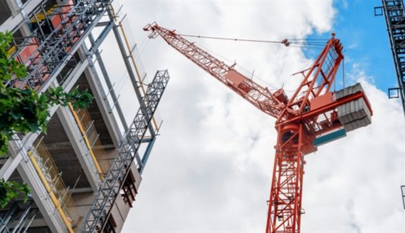 Crane next to block of flats under construction