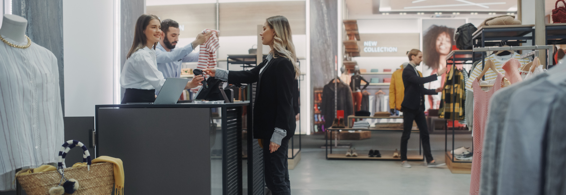 Woman being served at till in a clothes shop