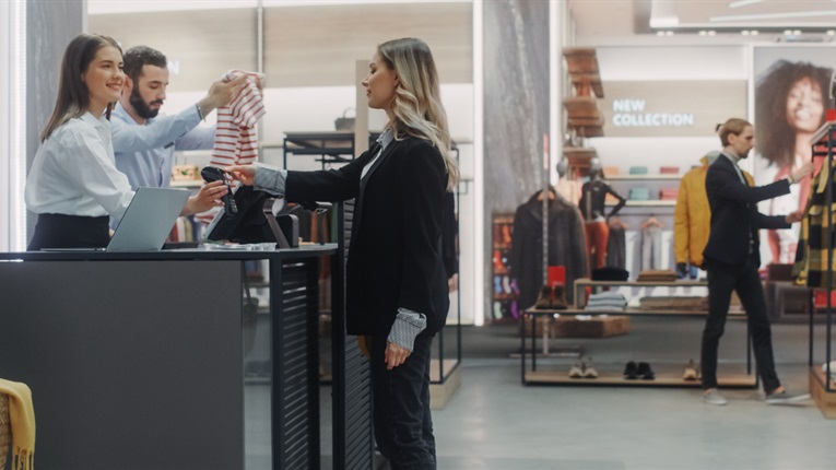 Woman being served at till in a clothes shop