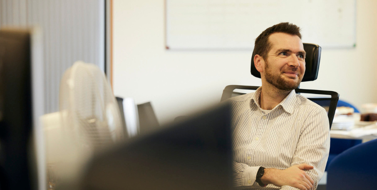 PPF colleague at desk, smiling