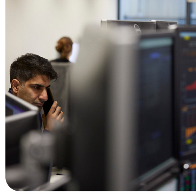 PPF investment colleague working at a computer while taking a phone call