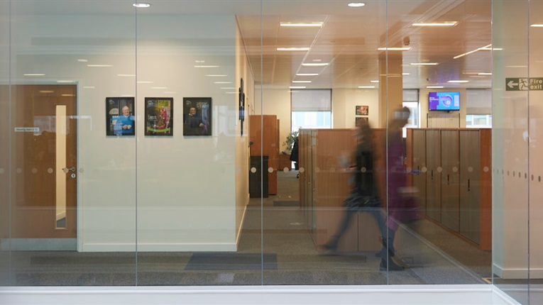 Office with people walking down a corridor