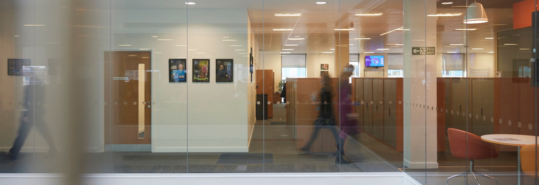 Office with people walking down a corridor