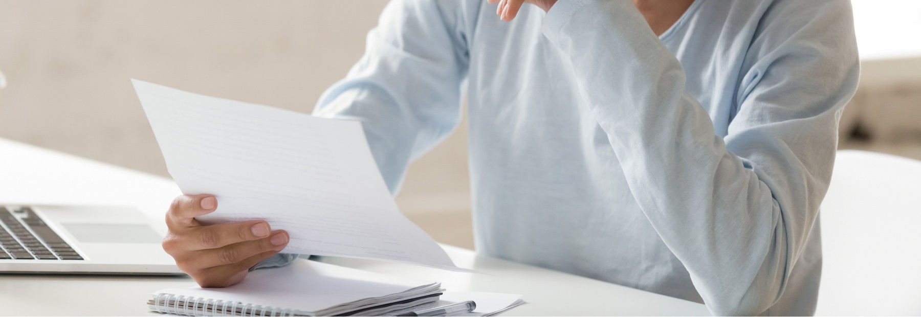 Letter in someone's hand sitting at table