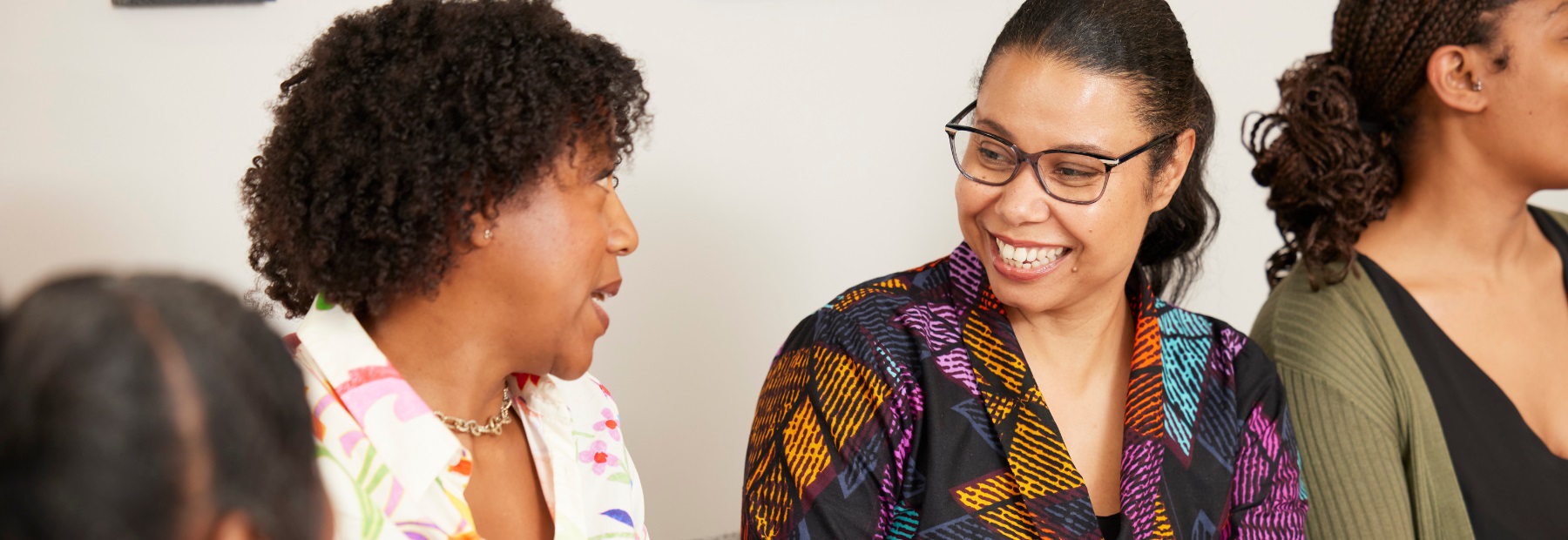 PPF colleagues sitting together, smiling and talking.