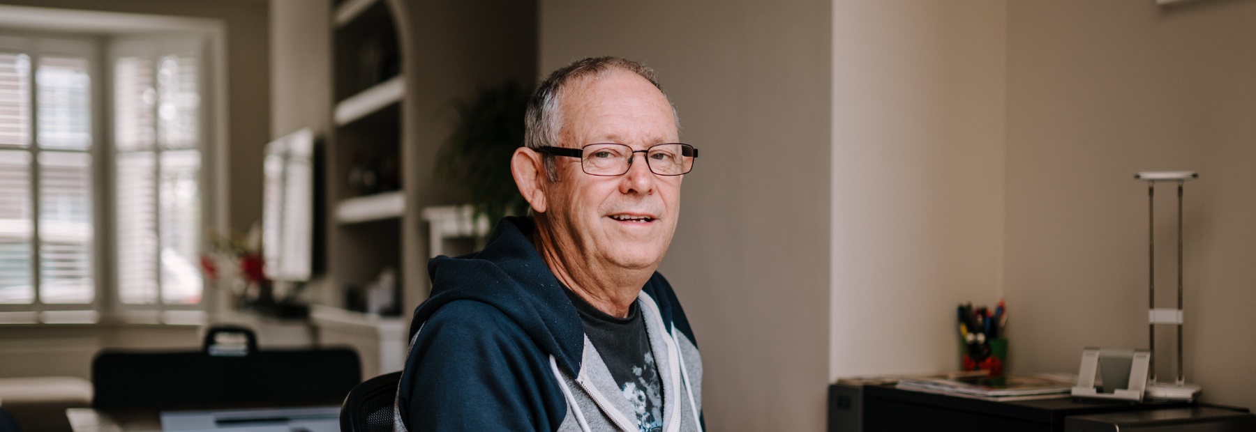 Man sat at home smiling